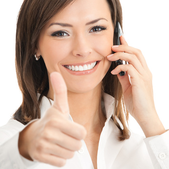Businesswoman with cellphone and thumbs up